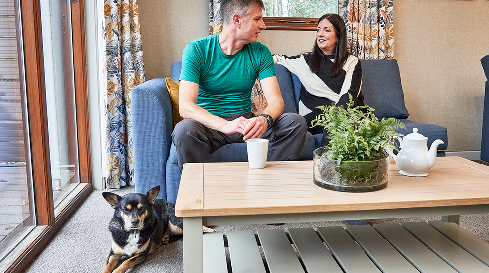 Patrick and his wife Steph inside a Whitemead apartment with dog Rosie